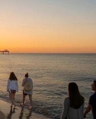 Family walking along the beach at sunrise in Gulf Shores