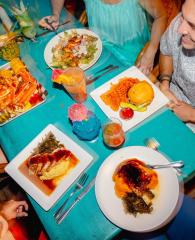 Aerial shot of people gathered around a table filled with food at GTs on the Bay