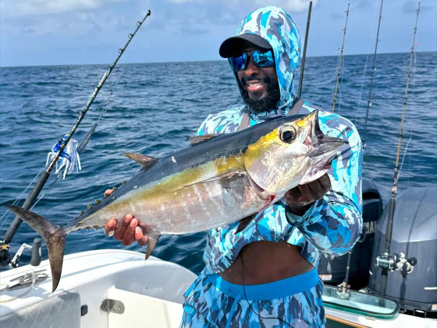 angler holding a tuna caught on a fishing charter in the Gulf