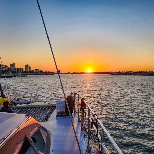 sunset cruise in orange beach with sail wild hearts