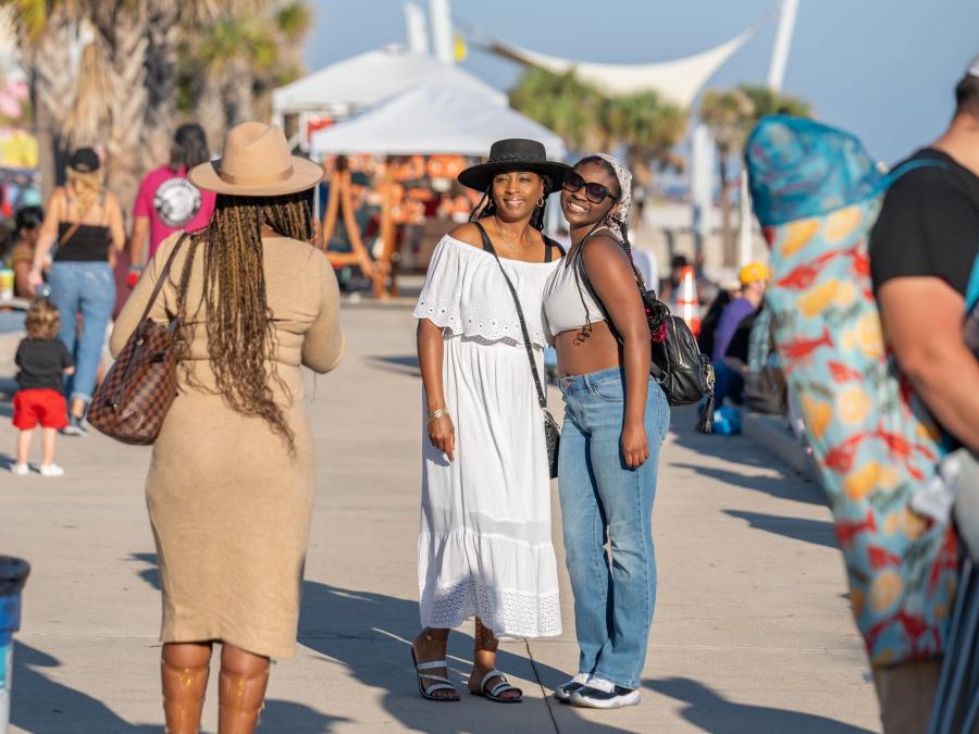 Friends talking a photo together at the Annual National Shrimp Festival in Gulf Shores