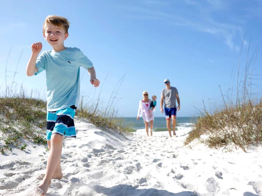 Family running on beach